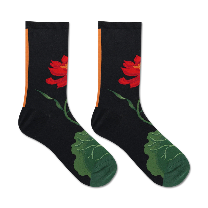 Pair of black crew socks. Features a red lotus flower and green leaves. Orange stripe detail at the top. }}