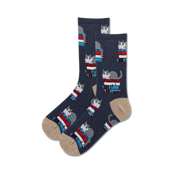 Close-up of dark blue crew socks with a tan cuff; featuring a pattern of grey cats on stacks of colorful books.