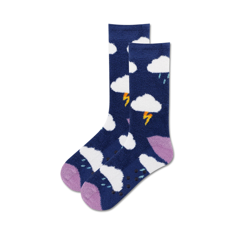 Pair of navy blue crew socks with a fluffy texture, featuring white clouds, yellow lightning bolts, and purple accents. Non-skid grips on the soles.