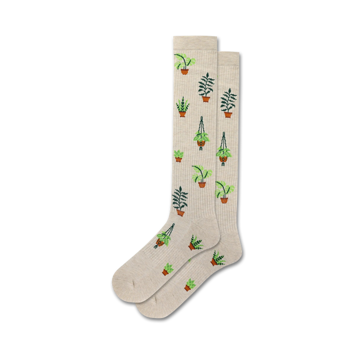 tan knee-high socks with an allover pattern of green plants in brown pots. ribbed top, reinforced heel and toe.  }}