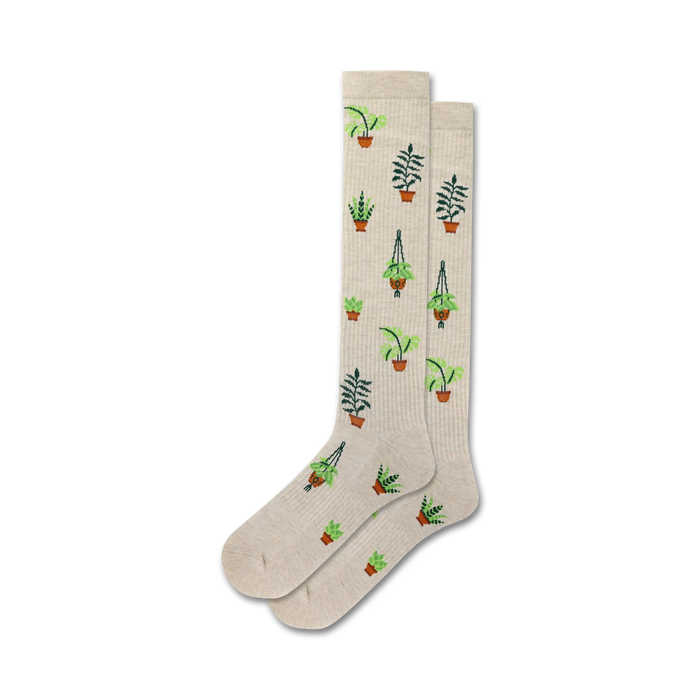 Pair of beige crew socks with a repeating pattern of potted plants in shades of green and brown. }}