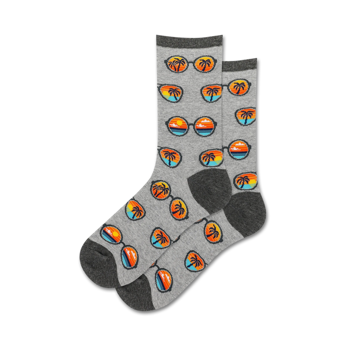 Pair of gray crew socks with a repeating pattern of sunglasses reflecting sunsets and palm trees. }}