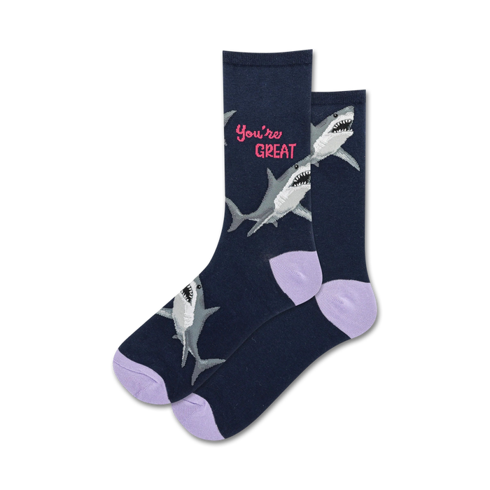 Pair of navy crew socks with light purple cuffs, featuring gray sharks and the text 'You're Great' in pink.