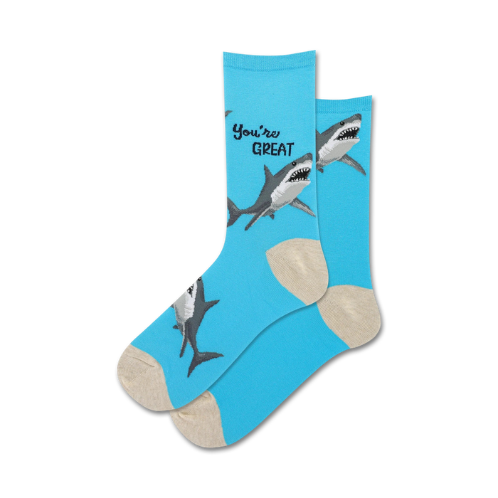 Lifestyle shot showing the light blue 'You're Great' socks with shark design on a person's feet.