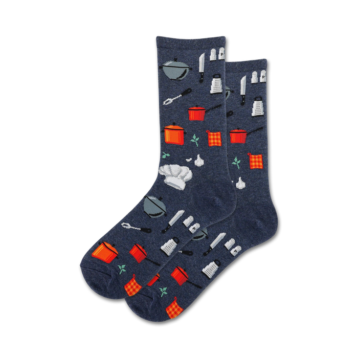 Pair of crew socks in navy blue featuring a pattern of kitchen utensils, chef hats, and checkered dish towels.