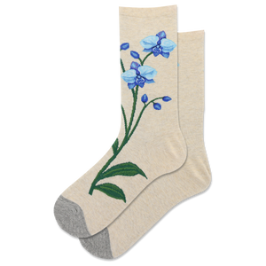 Pair of women's crew socks in beige featuring embroidered blue orchids. Grey heel and toe.