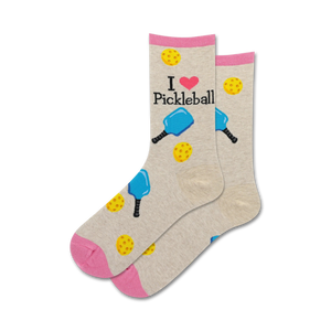 Pair of crew socks in beige and pink.  The socks feature 'I love Pickleball' text and illustrations of pickleball paddles and balls.