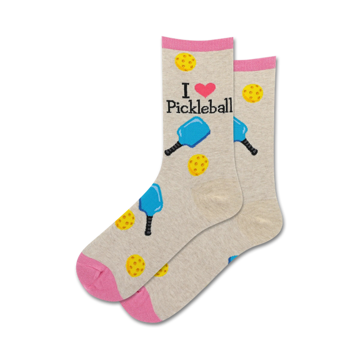 Pair of crew socks in beige and pink.  The socks feature 'I love Pickleball' text and illustrations of pickleball paddles and balls.