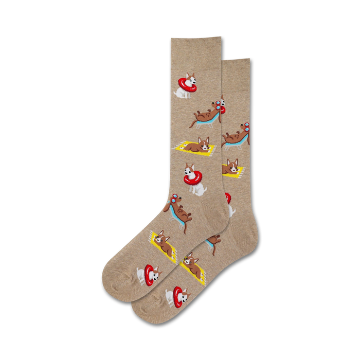 Pair of tan crew socks with a repeating pattern of cartoon dogs lounging on beach towels and in inflatable rings.