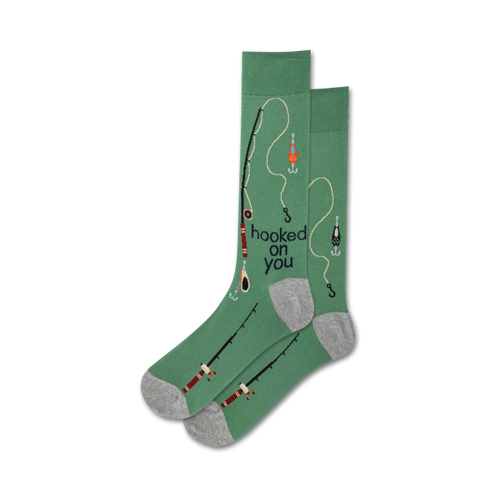 Lifestyle shot showing the green 'Hooked On You' socks on a person's feet. The socks feature a fishing-themed design.