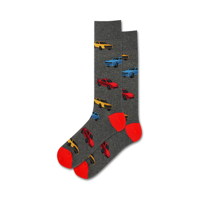 Pair of crew socks in gray with a pattern of red, blue, and yellow 1980s cars. Red and orange heel and toe. }}