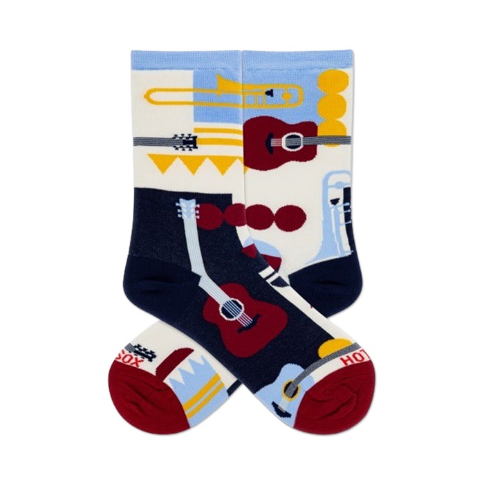 Pair of crew socks in navy, cream, and light blue, featuring a retro-style design of musical instruments like guitars and trumpets.