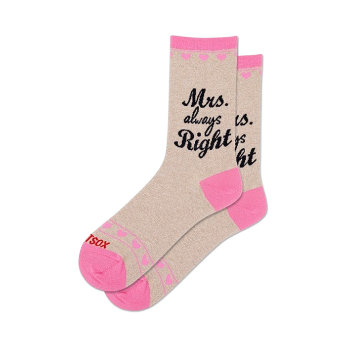 Beige crew socks with a pink cuff and small pink hearts.  Black script reads,