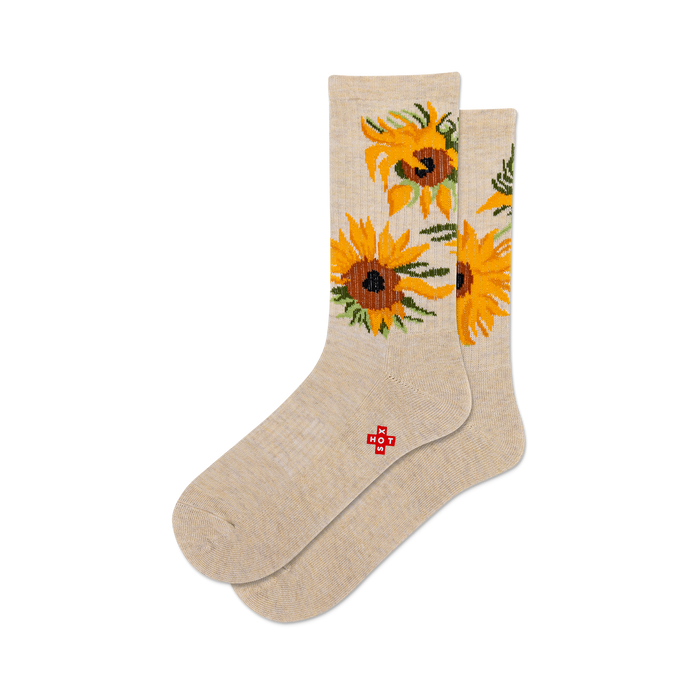 Pair of beige crew socks featuring a sunflower design. Yellow and brown sunflowers are displayed on a light beige background. }}