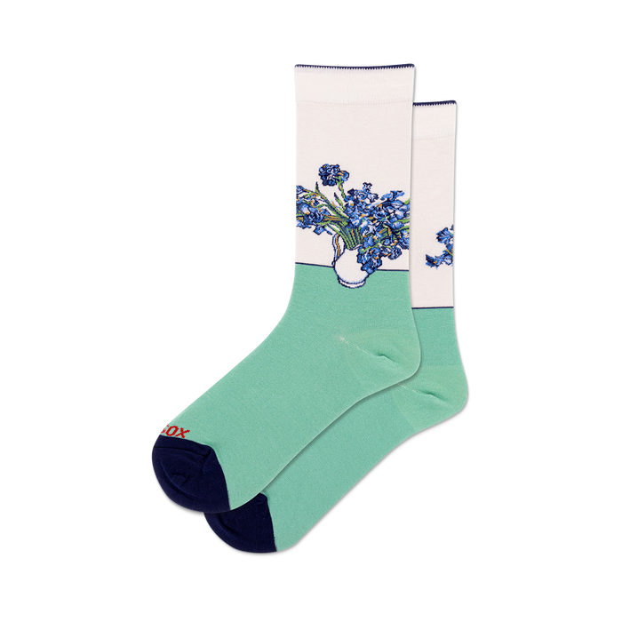 Pair of crew socks with a design featuring Van Gogh's Irises in shades of blue and purple on a white and light green background. Dark navy blue heel and toe. }}