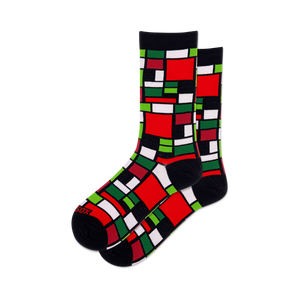Pair of crew socks featuring a Mondrian-inspired geometric design in red, green, black, and white squares.
