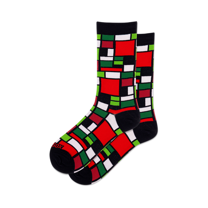 Pair of crew socks featuring a Mondrian-inspired geometric design in red, green, black, and white squares.