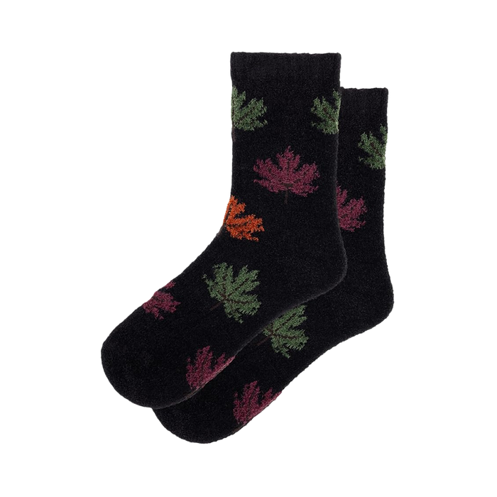 Pair of black fuzzy socks with colorful autumn leaf pattern. Crew-length socks in dark and muted colors. }}