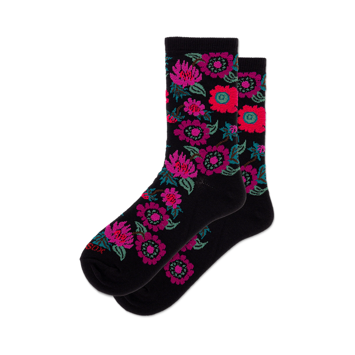 Pair of black crew socks with a colorful floral pattern featuring pinks, purples, and reds.
