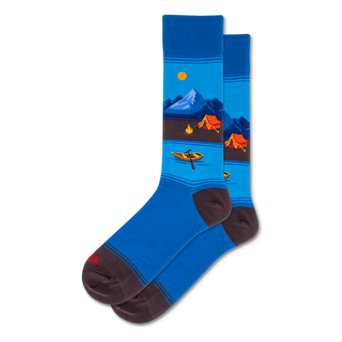 Pair of crew socks with a scenic blue mountain lake, orange tents, canoe, and sun pattern. Dark brown cuffs, heels, and toes.