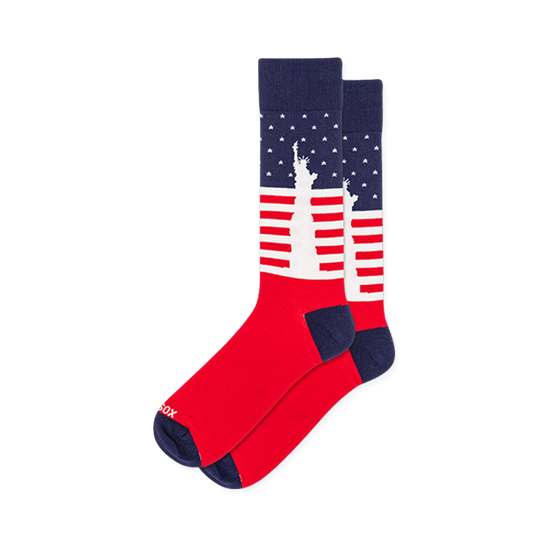 Crew socks featuring a white silhouette of the Statue of Liberty against a backdrop of navy blue with stars and red stripes.