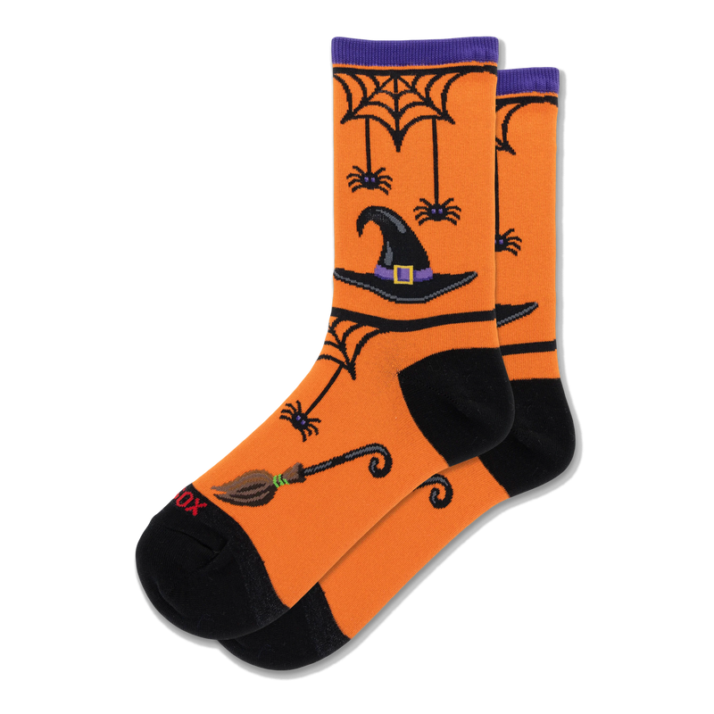 Orange crew socks with black witch hats, spiderwebs, dangling purple spiders, and broomsticks. Purple cuff and black toes.