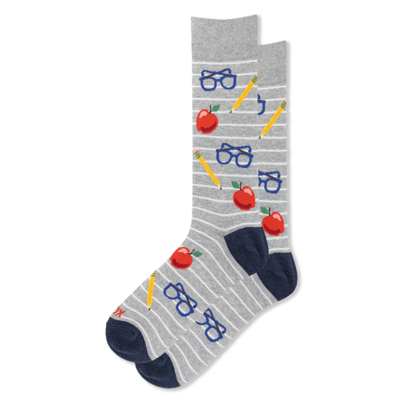 Grey crew socks with white stripes featuring a pattern of red apples, yellow pencils, and blue eyeglasses with navy heels.