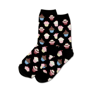 Close-up of black crew socks with a pattern of cupcakes in pink, blue, and brown.