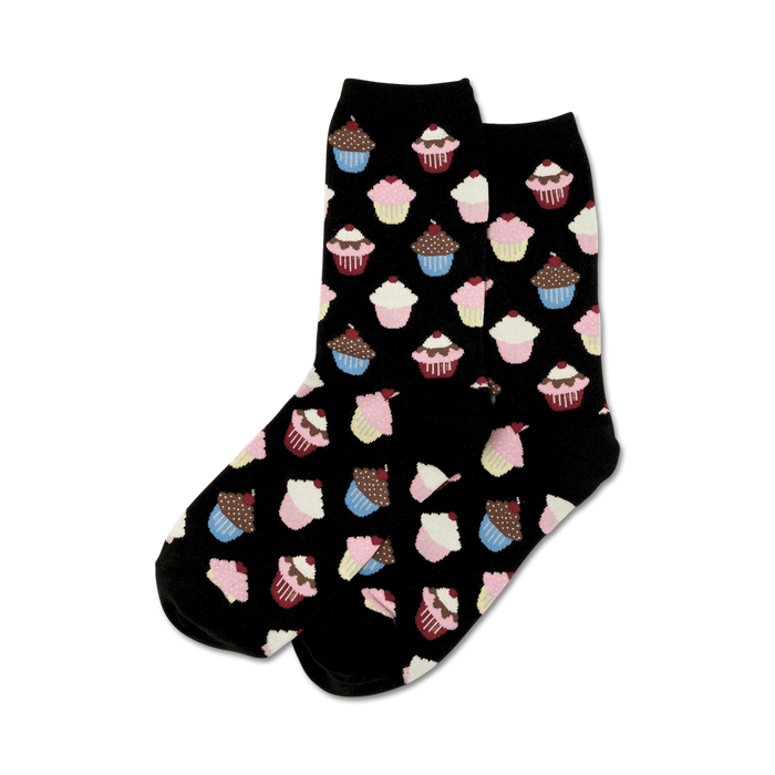Close-up of black crew socks with a pattern of cupcakes in pink, blue, and brown.