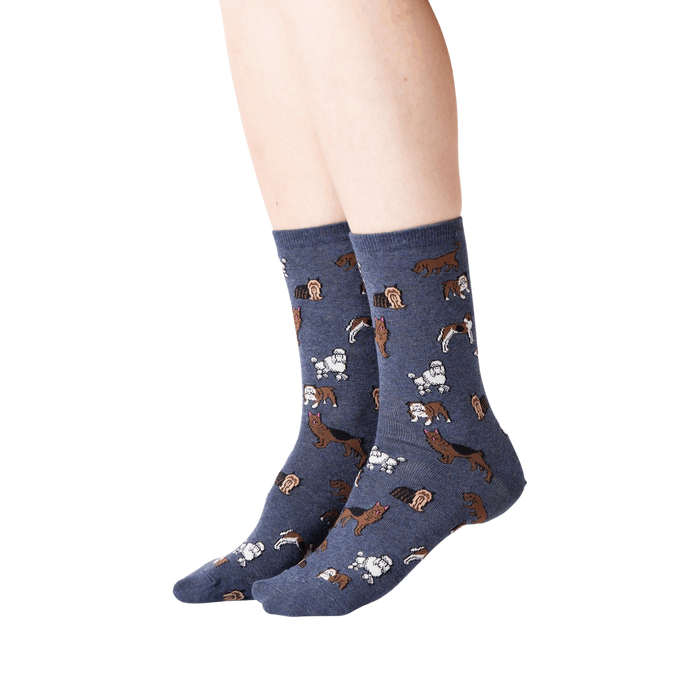 Lifestyle shot of woman's legs wearing navy blue crew socks with dogs on them.