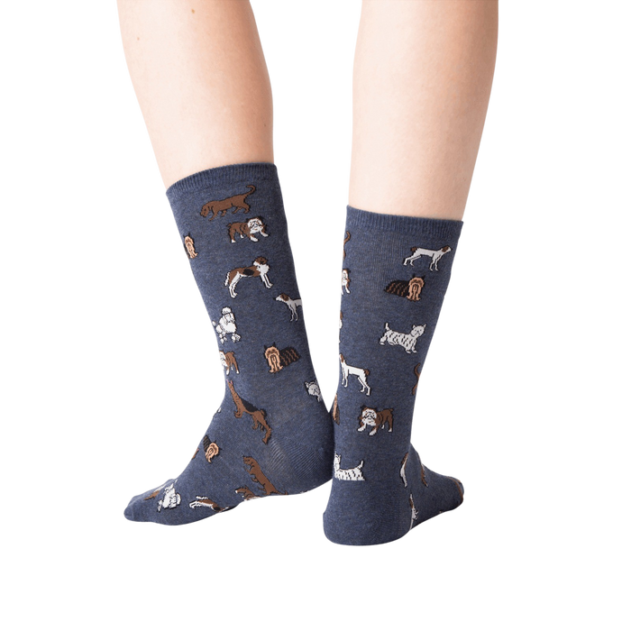 Back view lifestyle shot of woman's legs wearing navy blue crew socks with dogs on them.