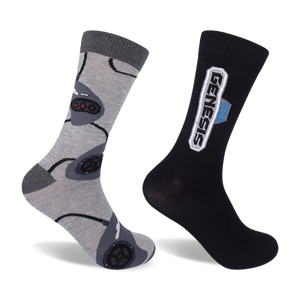 Two crew socks; one grey with repeating Sega Genesis controller designs, the other black with a white Sega Genesis logo.