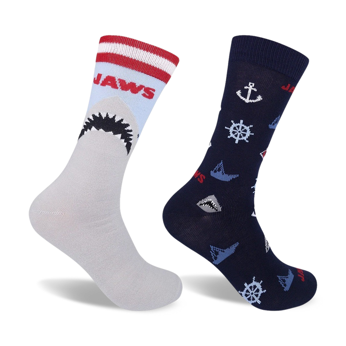 Two crew socks. One gray with red/white stripes and a Jaws shark graphic; one navy blue with nautical anchors, wheels, and small shark graphics.