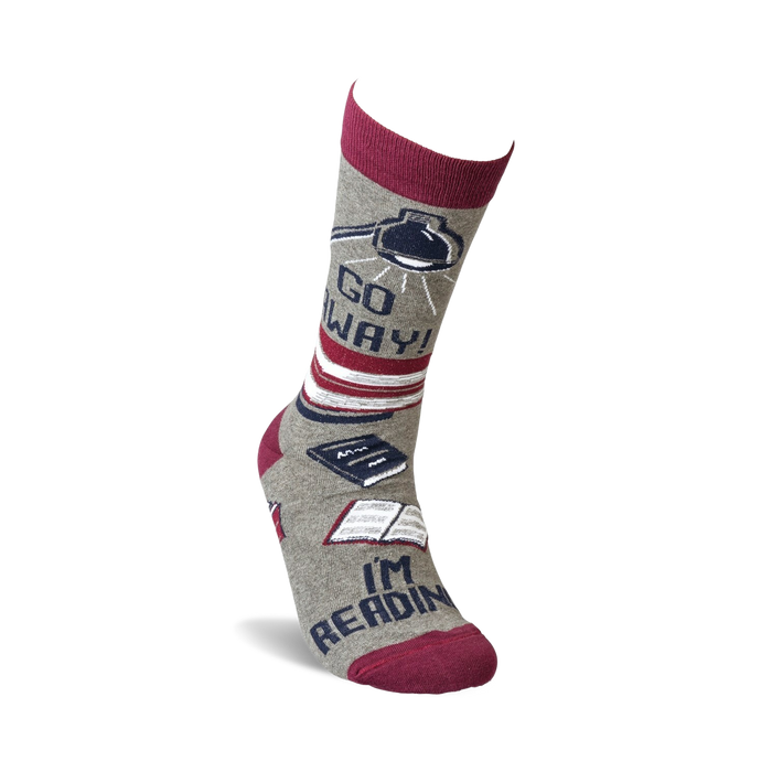 Single grey crew sock with burgundy cuff, showing the full design detail of books and lamp, 'Go Away!' and 'I'm Reading'.