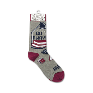 Lifestyle shot showing one 'Go Away! I'm Reading' sock on a foot, showcasing how the socks look when worn.