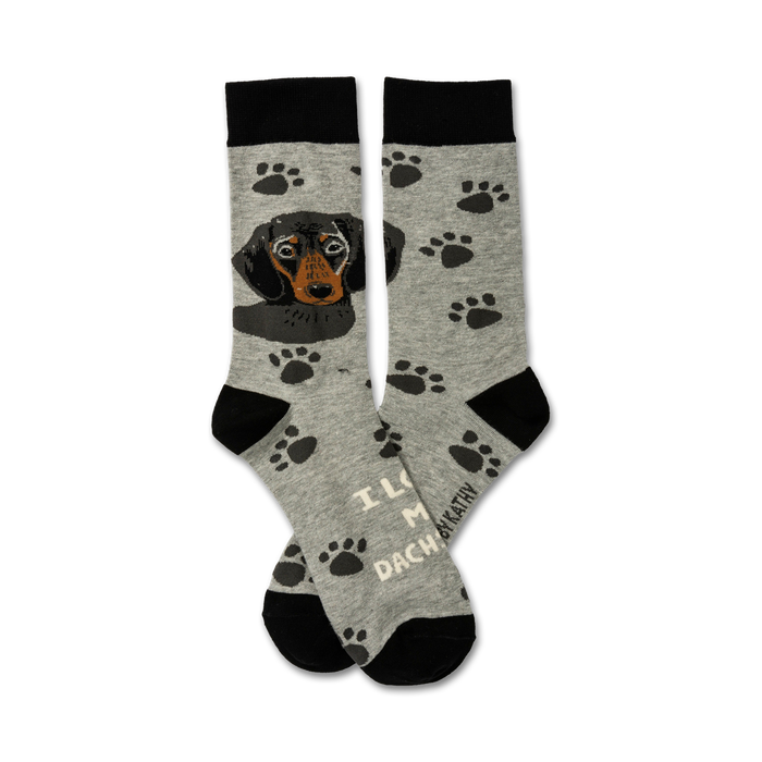 A pair of grey crew socks with black paw prints and a black and tan Dachshund image. Text reads 'I Love My Dachshund'. }}