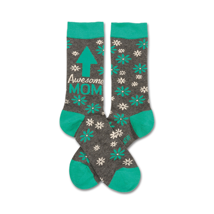 Pair of gray crew socks with teal accents.  Features white flowers, a teal arrow pointing up, and the text 'Awesome Mom'. }}