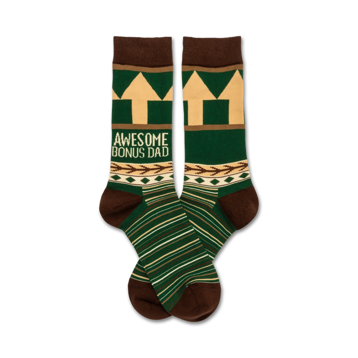 A pair of crew socks in green, brown, and beige.  They feature a geometric pattern, arrows, and the text 'Awesome Bonus Dad'. }}
