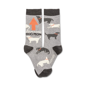 Gray crew socks with a repeating pattern of black and white dogs, an orange arrow, and the text 'Awesome Dog Mom'.