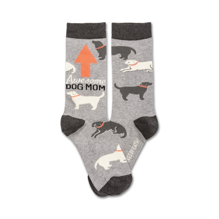Gray crew socks with a repeating pattern of black and white dogs, an orange arrow, and the text 'Awesome Dog Mom'.