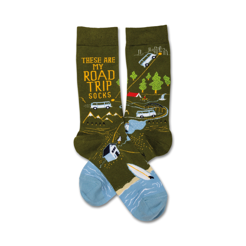 Pair of crew socks; olive green with light blue accents; illustration of road trip scenes, including vans, mountains, and a campsite.