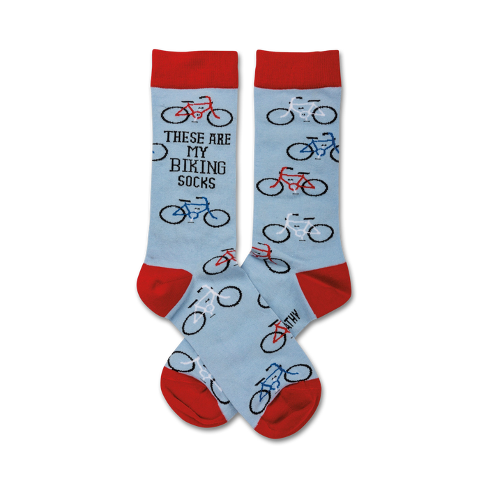 Pair of light blue crew socks with red and blue bicycle designs and the text 'These Are My Biking Socks'. }}