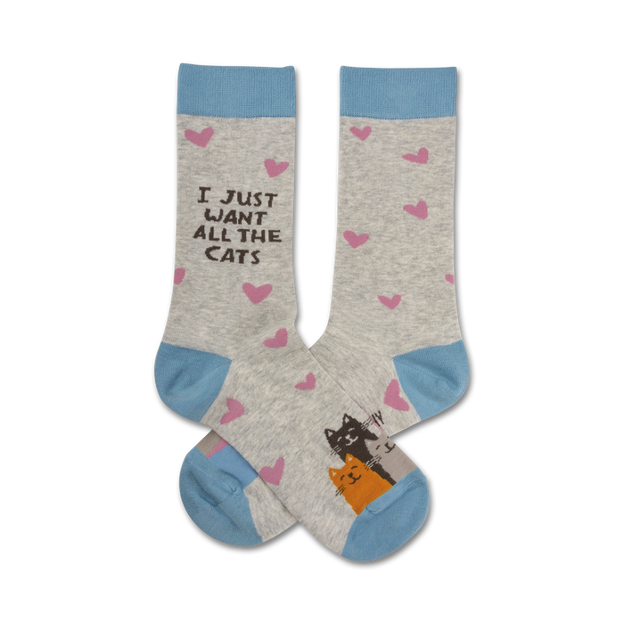 Pair of crew socks in grey with light blue cuffs.  Pink hearts and a drawing of two cats are featured on the socks. The text 'I Just Want All The Cats' is also displayed. }}