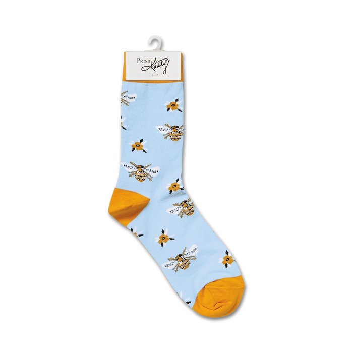 Single light blue crew sock with yellow bee and flower pattern hanging on a display hook.