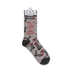 Product shot of a single 'I Don't Give A Shit' sock hanging on a retail display tag.