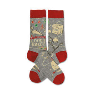 Grey crew socks with a red cuff.  The design features illustrations of cookie baking tools and ingredients, along with the text 'Awesome Cookie Baker'.