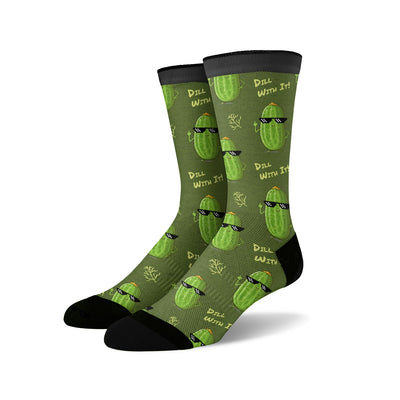 Crew socks in olive green with a repeating pattern of cartoon pickles wearing sunglasses and the phrase 'Dill With It'.