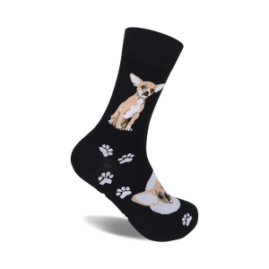 A pair of black crew socks with a tan Chihuahua and paw print design.