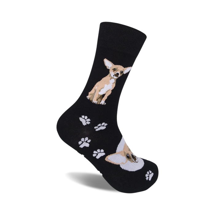 A pair of black crew socks with a tan Chihuahua and paw print design.