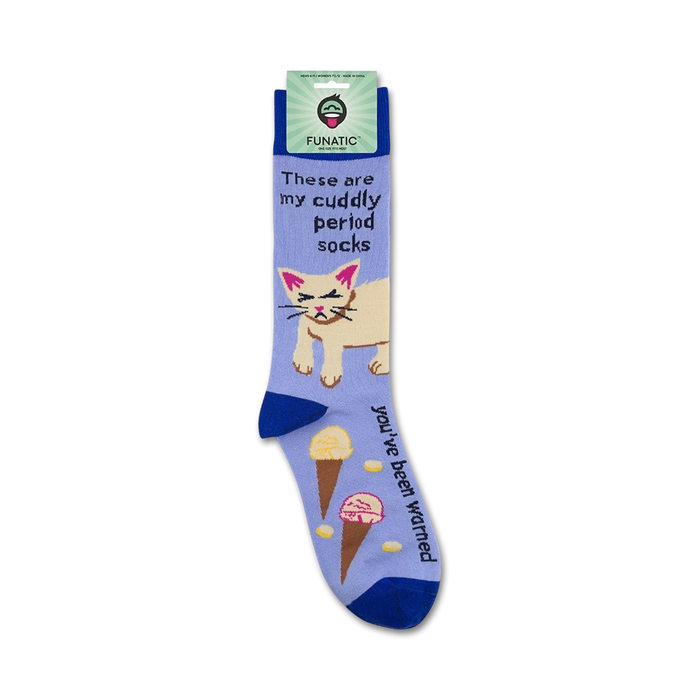 A pair of blue socks with a white cat on them. The cat has its eyes rolled up and is surrounded by two ice cream cones and some pills. The text on the socks reads: 